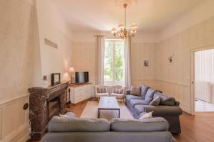 a living room with two couches and a fireplace at Ancien pavillon de chasse du château de Chaumont sur Loire in Chaumont-sur-Loire