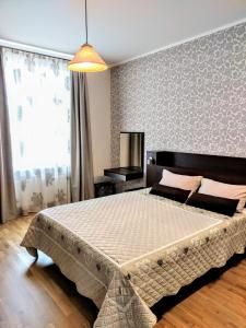 a bedroom with a large bed in a room at Peter House in Ventspils