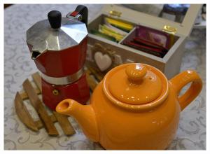 an orange toy teapot sitting on top of a table at Domus Dea in Venice