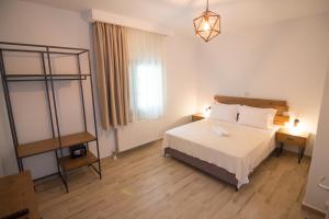 a hotel room with a bed and a window at Casa Luxury Suites in Paliouri