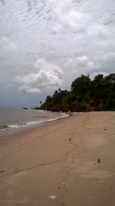 a beach with footprints in the sand and the ocean at Airport Lodge Lungi in Lungi