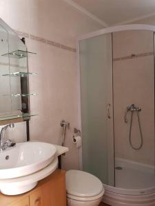 a bathroom with a toilet and a sink and a shower at Holiday Home Banalu in Jadranovo