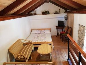 a room with a bed and a table and chairs at Holiday Home Banalu in Jadranovo