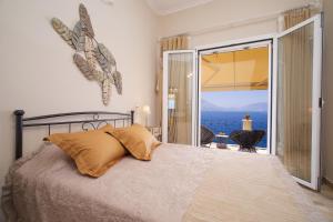 Villa Apoplous with pool في أسوس: غرفة نوم مع سرير وإطلالة على المحيط