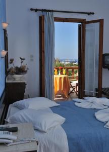 a group of four beds in a room at Eri Hotel in Parikia