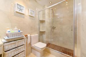 a bathroom with a toilet and a shower at Boutique Penhouse in the City Old Town in Alicante +14 photos