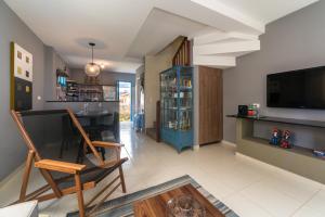 a living room with a bar and a tv at Casa Azul Home Stay in Porto De Galinhas