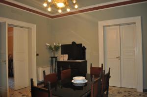 a dining room with a table and a tv at B&B Teatro Bellini in Catania