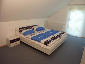 a bedroom with a large bed with blue and white sheets at Ferienhaus Alina in Salem