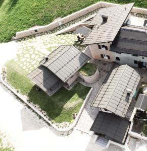 an overhead view of a house with a group of roofs at Regensburgerhof in Castello Tesino