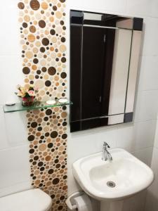 a bathroom with a sink and a mirror at Hotel el mesón Tinjacá in Tinjacá