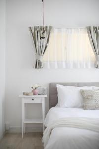 Ένα ή περισσότερα κρεβάτια σε δωμάτιο στο Bijou Suites Sorriso