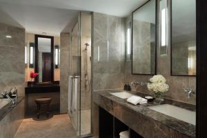 a bathroom with a sink and a shower at Anantara Riverside Bangkok Resort in Bangkok