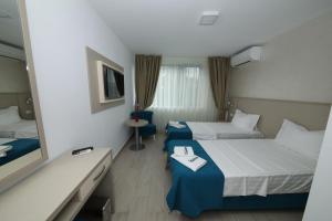 Postel nebo postele na pokoji v ubytování Hotel Delfin