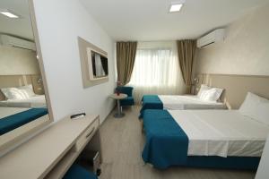 Postel nebo postele na pokoji v ubytování Hotel Delfin