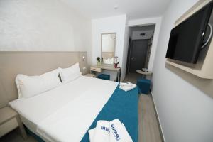 Postel nebo postele na pokoji v ubytování Hotel Delfin