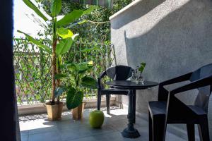 a patio with a table and chairs and plants at Inspirational Apartment in Tel Aviv