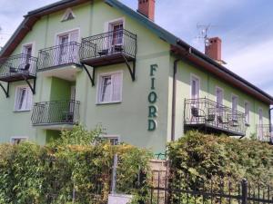 a building with balconies on the side of it at Fiord in Mielno