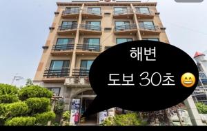 a sign in front of a tall building at Venus Motel in Boryeong