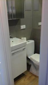 a white bathroom with a toilet and a sink at mieszkanie in Gdynia +22 photos