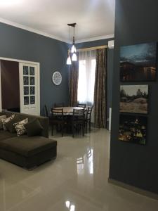 a living room with a couch and a table at Sweet Home Freedom Square in Tbilisi City