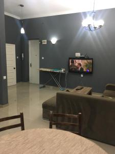a living room with a flat screen tv on a wall at Sweet Home Freedom Square in Tbilisi City