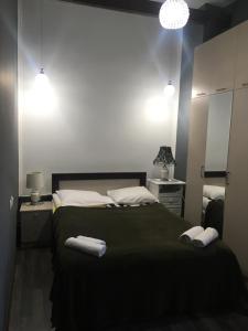 a bedroom with a bed with two towels on it at Sweet Home Freedom Square in Tbilisi City