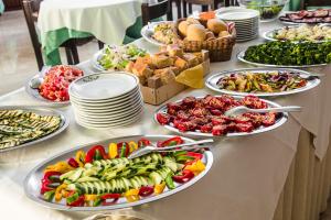 a table with many plates of food on it at Holiday in Milano Marittima +13 photos