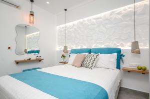 a bedroom with a large blue and white bed at 3 Wishes in Naxos Chora