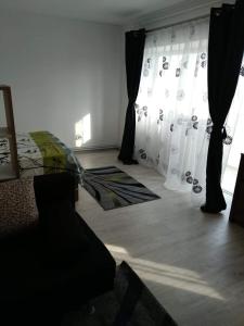 a bedroom with a bed and curtains in a room at Central Residence Constanta in Constanţa