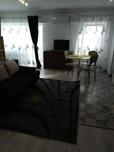 a living room with a couch and a table at Central Residence Constanta in Constanţa