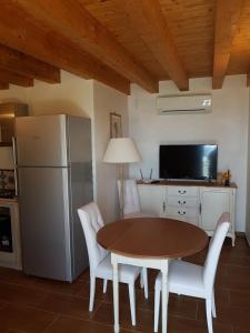 a kitchen with a table and a refrigerator at Suite Panoramic in Porticello