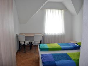 Postel nebo postele na pokoji v ubytování August Restaurant Hotel
