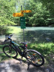 a bike is parked next to a street sign at Hotel Arkanum in Salgesch