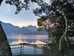 a view of a lake with mountains in the background at Sun Moon Lake FRIDAY Inn Guest House in Yuchi