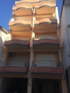 a building with balconies on the side of it at Theros Apartment Preveza in Preveza +10 photos