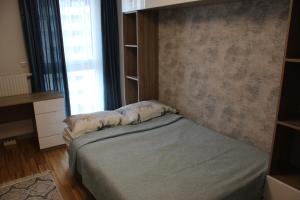 a bedroom with a bed and a book shelf at Park Vienna Hauptbahnhof Apartments in Vienna