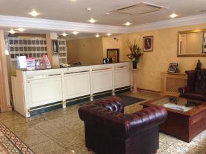 a living room with a leather chair and a counter at Troy Hotel in London