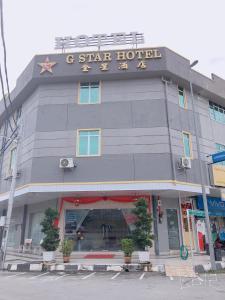 a star hotel on the corner of a street at G Star Hotel in Pantai Remis