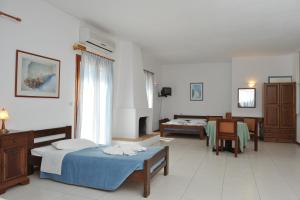 a hospital room with two beds and a table at Eri Hotel in Parikia