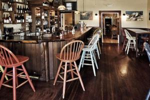 a bar with wooden stools and a bar counter at Valley Ford Hotel in Valley Ford