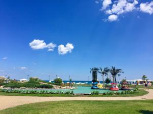 a park with a playground and the ocean in the background at Helga Apartment in Obzor