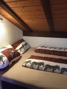 a room with three beds with zebras on them at Hegau-Lounge-Bodensee in Mühlhausen-Ehingen