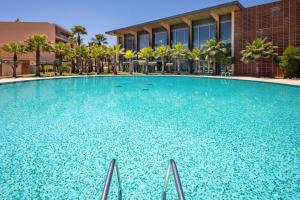 a large swimming pool in front of a building at the Quest - Luxury Beach Apartment in Albufeira
