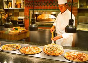 a chef preparing pizzas in a restaurant kitchen at Grand Sierra Resort and Casino in Reno