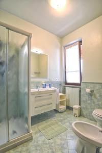 a bathroom with a shower and a sink and a toilet at Residence Erika in Tignale