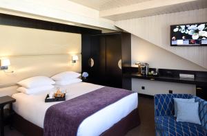 Postel nebo postele na pokoji v ubytování Hôtel Tiffany by Fassbind