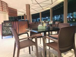 a dining room with a table and chairs in a building at KSL Hot Spring Resort in Johor Bahru
