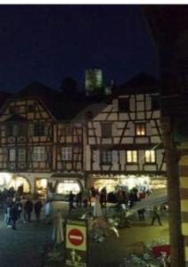 a building with people standing outside of it at night at Coeur d'Alsace 1 in Kaysersberg