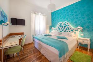Ένα ή περισσότερα κρεβάτια σε δωμάτιο στο Piccolo Grand Hotel